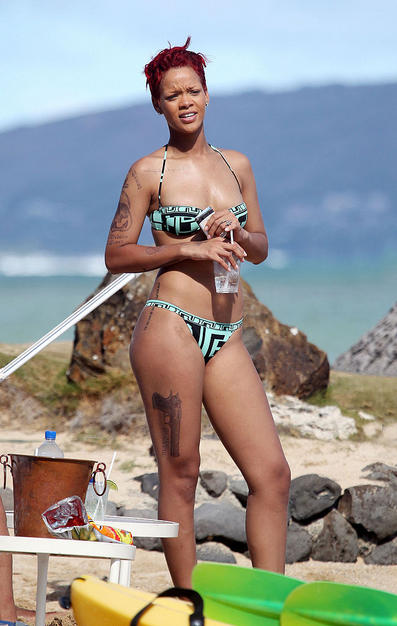 Singer Rihanna Sporting a Pistol Temporary Tattoo